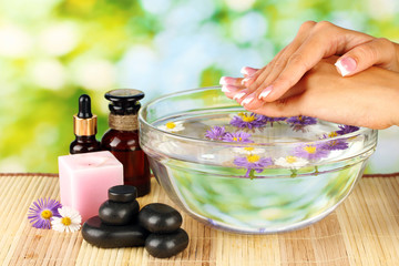 spa treatments for female hands,  on bright green background