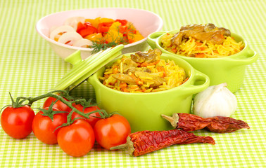 Delicious pilaf with vegetables on tablecloth background