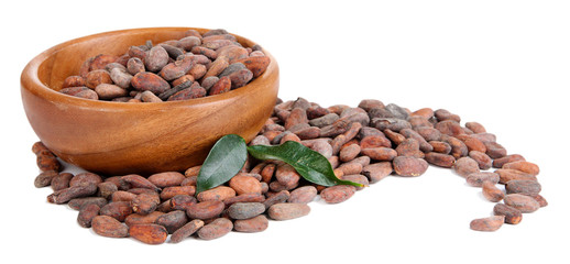 Cocoa beans in bowl with leaves, isolated on white