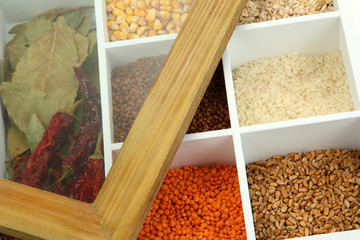 Assortment of cereals in white wooden box close up