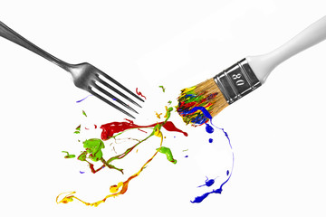 Paint splash between fork and paintbrush