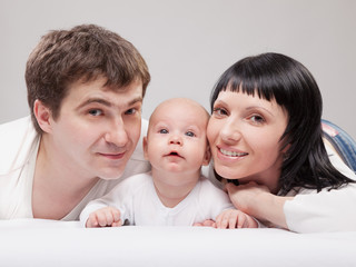 Portrait of a young happy family with the kid