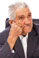 Closeup of an elderly man looking away in deep thought