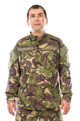 Portrait of a young soldier looking at camera isolated