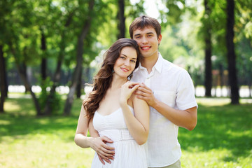 Fototapeta premium Young love Couple smiling under blue sky