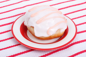 Donut glaze on a striped tablecloth