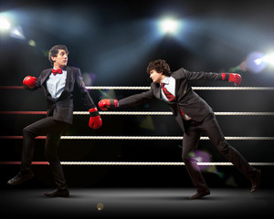 Fototapeta na wymiar Two young businessman boxing