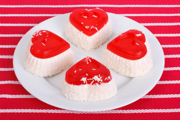 Four cheese cake in the form of heart on a white plate