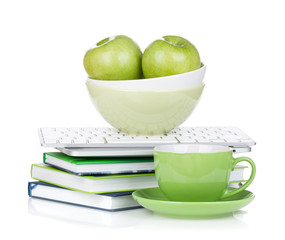Ripe green apples, coffee cup and office supplies