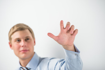 Young positive business man touching virtual button. Editable im © Milles Studio