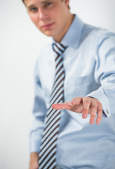 Young positive business man touching virtual button. Editable im © Milles Studio