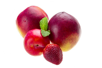 Ripe bright peaches, plum, strawberry and mint