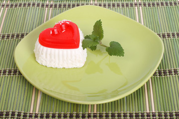 The gelled cake with mint on green plate