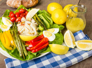Crab salad with asparagus loaf of bread and lemon