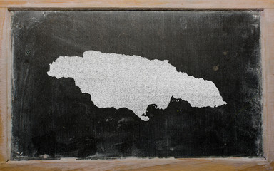 Teacher showing map of jamaica  on blackboard