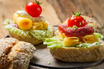 Sandwich with salami, tomato, cheese and lettuce
