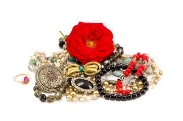 various jewellery with red rose isolated on white