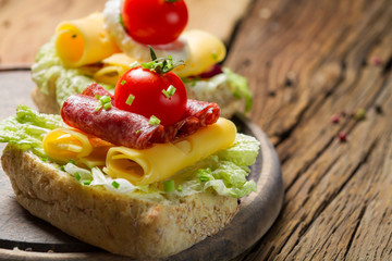 Sandwich with salami, chive and lettuce