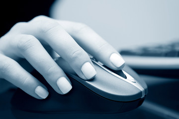 Female hand holding computer mouse