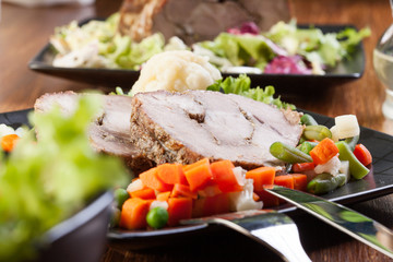 Pork roast with vegetable. Dark tone