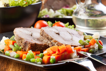 Pork roast with vegetable. Dark tone