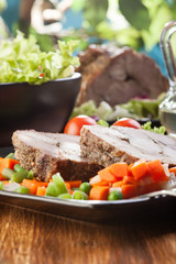 Pork roast with vegetable. Dark tone