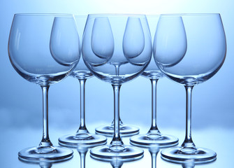 Empty wine glasses arranged on blue background