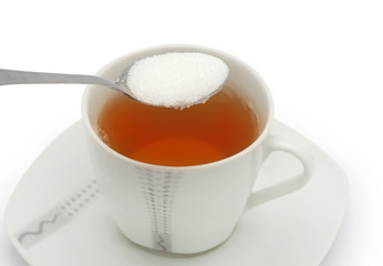 Cup of tea with sugar isolated on white