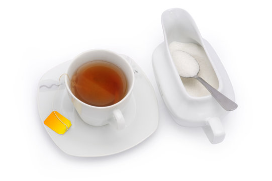 Cup of tea with sugar isolated on white