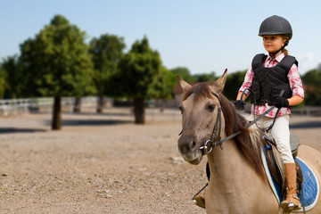 Horse riding - lovely girl is riding on a horse