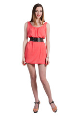 Beautiful female fashion model posing in pink dress