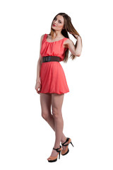 Beautiful female fashion model posing in pink dress