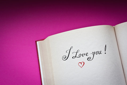 I love you! vintage words in the open book with pink background
