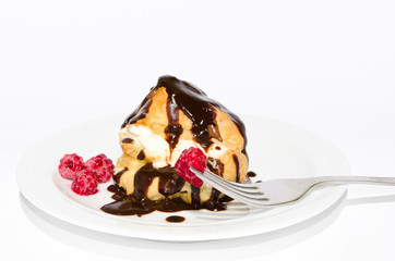 eclair in a chocolate with a raspberry