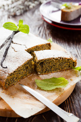 poppy seed cake on a wooden board and knife