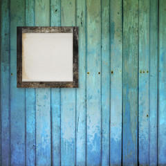 blank photo frame on wood background