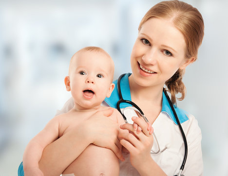 Pediatrician woman doctor holding patient baby