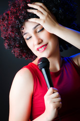 Naklejka premium Female performer at disco with mic