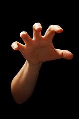 hand in grabbing position isolated over black background