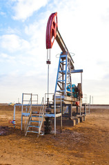 Fototapeta na wymiar Oil pump on a background of blue sky