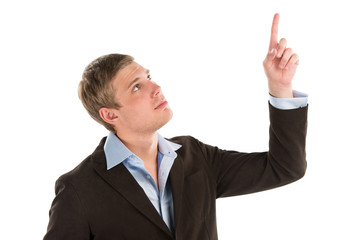 A confident young businessman pointing upwards while isolated on