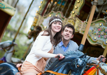 Fototapeta na wymiar Beautiful couple on a merry-go-round