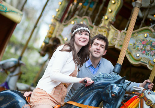 Beautiful couple on a merry-go-round