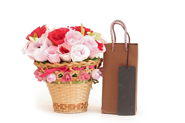 Fototapeta na wymiar Paper flower in a basket with shopping bag