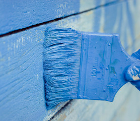 hand painting blue wooden wall 