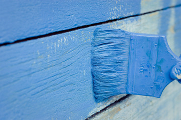 hand painting blue wooden wall 