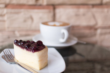 Hot coffee  and blueberry cheesecake.
