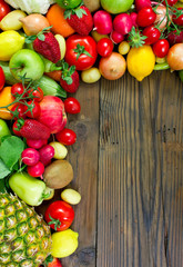Fresh fruits and vegetables on the old wooden board