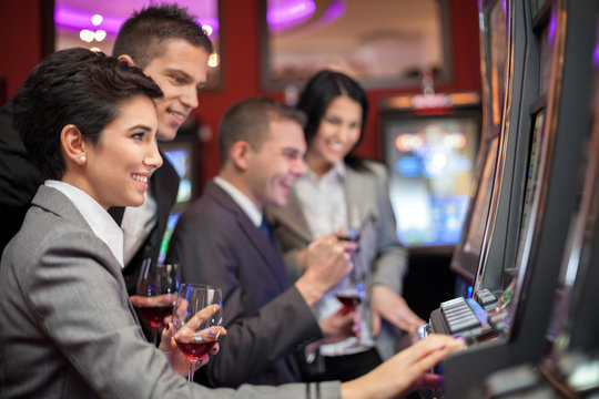 Young people enjoying to play slot machines