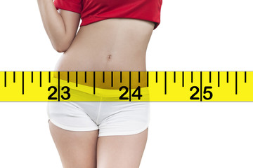 Woman measuring perfect shape of beautiful hips